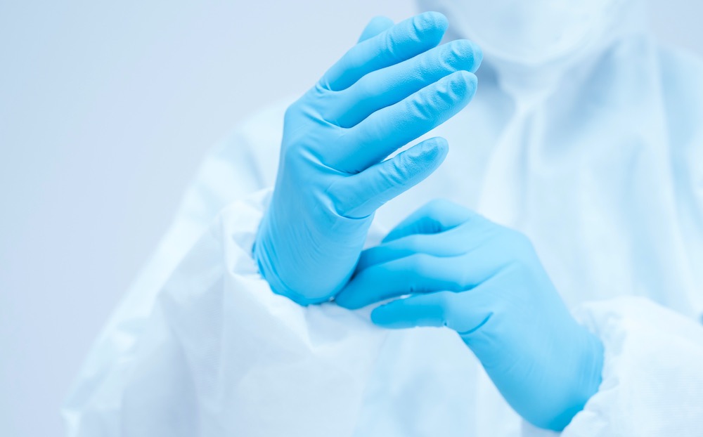 Nurse putting on surgical gloves